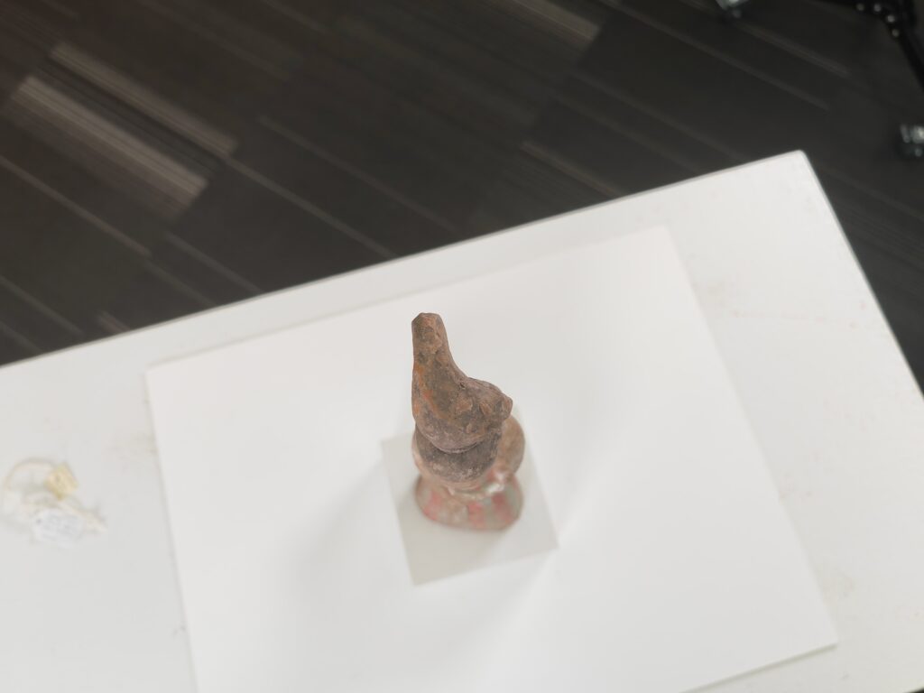 top view of a 12 1/2 x 3 1/4 x 2 1/4 in. (32 x 8 x 6 cm) tomb figure of a court lady
